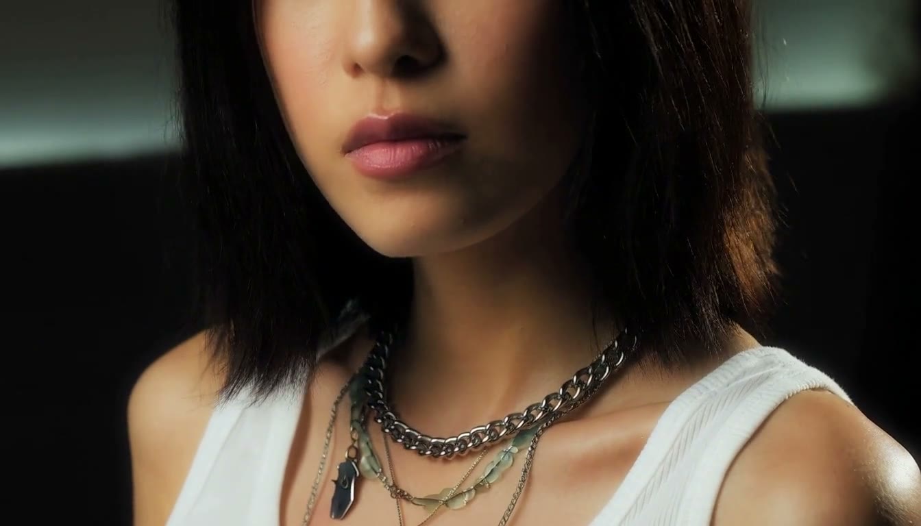 MiniMax H3 AI video example showing a young woman with shoulder-length dark hair and a white tank top adorned with layered necklaces